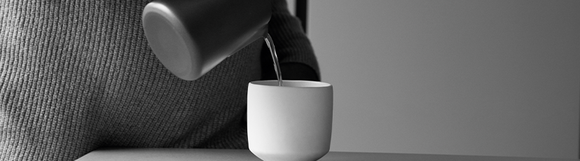 Close up on a mug where someone is pouring a drink in