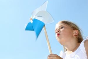 Picture of a little girl blowing on a mini windmill