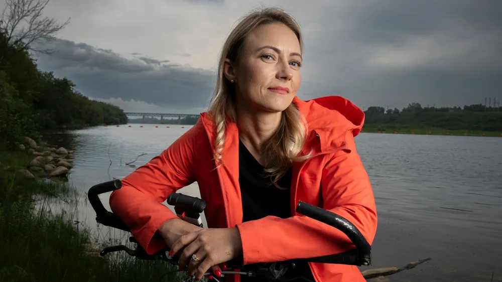 Picture of Candace living with myasthenia gravis cycling around a lake