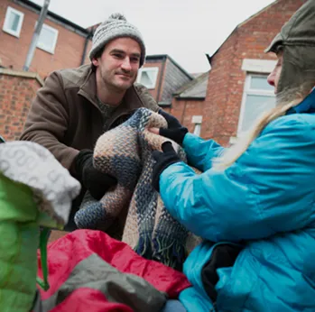 Picture showing someone helping a homeless person
