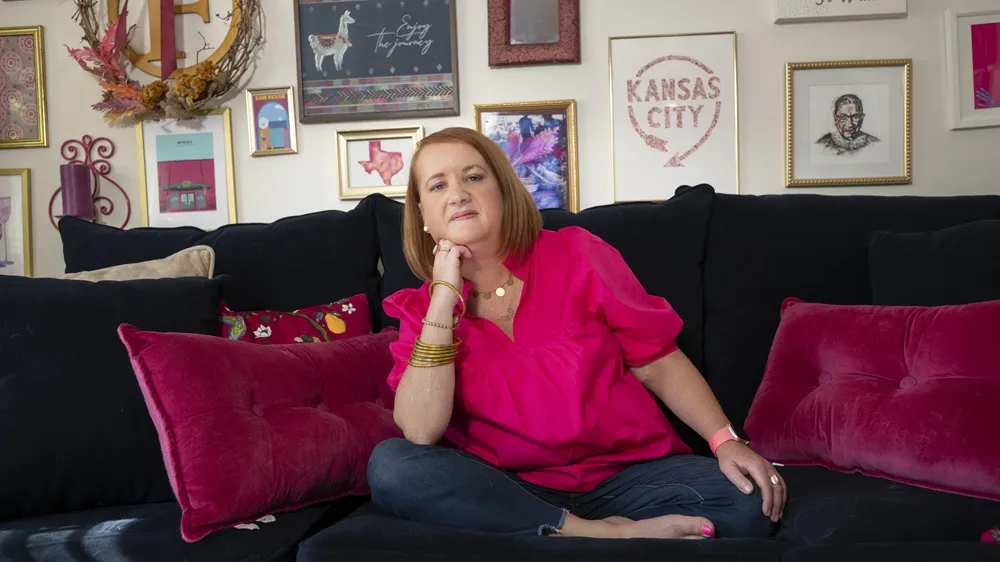 Picture of Allison, Executive Director for the Myasthenia Gravis Association, living with myasthenia gravis sitting on her sofa